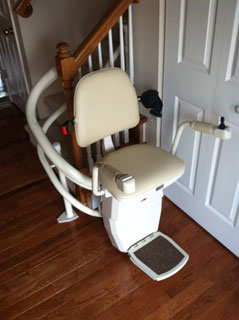 Curved stairlift at bottom of stairs